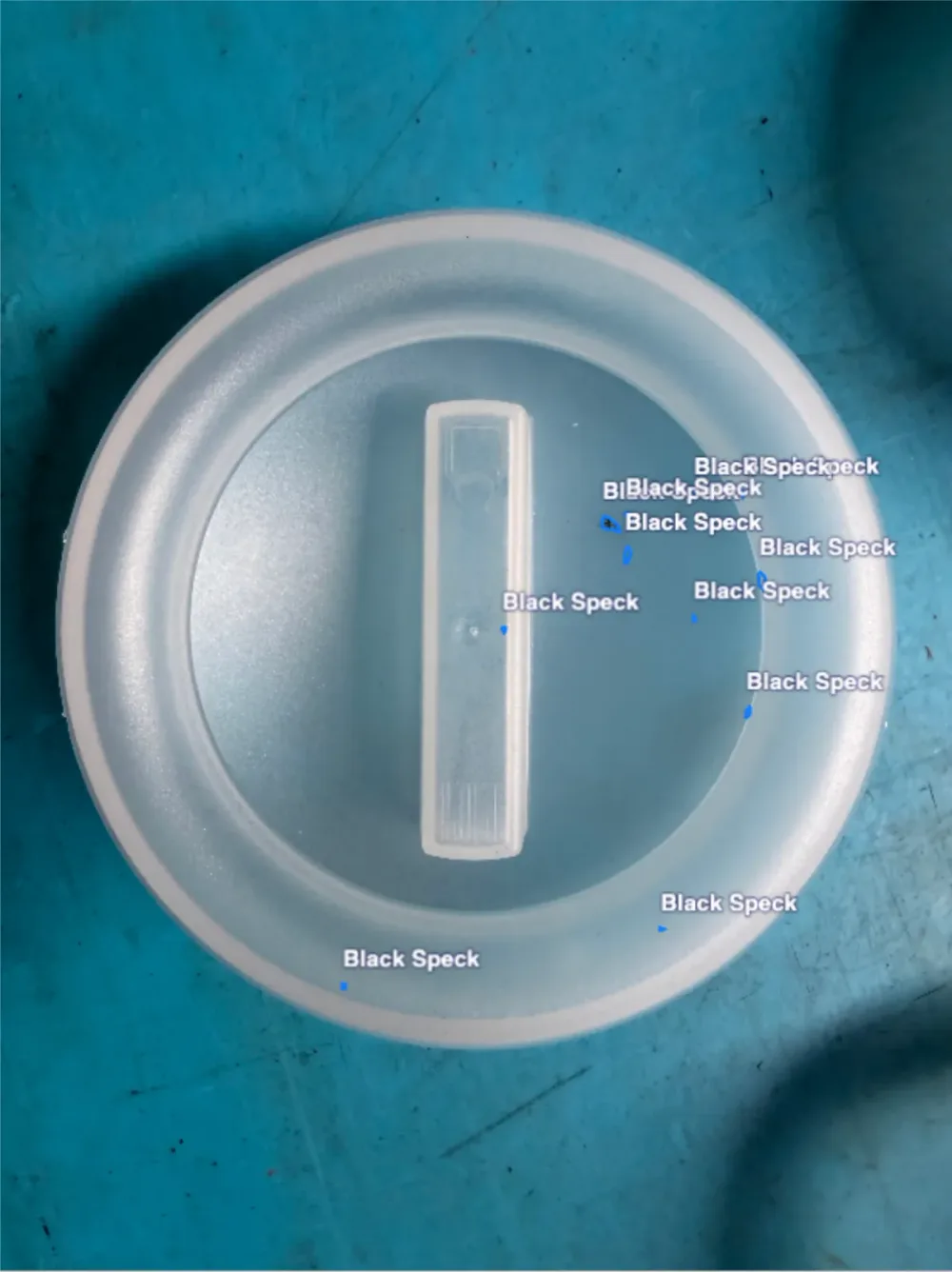 Black specks on a closure — the fault marked on the part